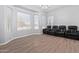 Bright living area with updated flooring, a bay window and leather seating at 1442 W Laurel Ave, Gilbert, AZ 85233