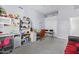 Finished basement with a gray floor, two desks, and a couch at 1442 W Laurel Ave, Gilbert, AZ 85233