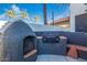 Outdoor kitchen area features built-in bbq, wood burning pizza oven and bar seating at 1442 W Laurel Ave, Gilbert, AZ 85233