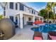 Backyard features a swimming pool, lush landscape, outdoor kitchen, and covered patio at 1442 W Laurel Ave, Gilbert, AZ 85233