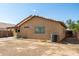 This backyard features a low-maintenance landscape, an air conditioner, an exterior building wall, and minimal landscaping at 15805 W Morning Glory St, Goodyear, AZ 85338