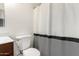 Bathroom featuring modern vanity with white countertop, dark wood cabinets, a toilet, and shower curtain at 15805 W Morning Glory St, Goodyear, AZ 85338