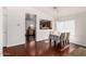Hardwood floors, dining table and chairs are featured in this dining room with natural light and views into the kitchen at 15805 W Morning Glory St, Goodyear, AZ 85338