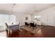 Hardwood floors, dining table and chairs are featured in this dining room with natural light at 15805 W Morning Glory St, Goodyear, AZ 85338