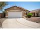 Charming single-story home featuring a two-car garage and desert landscaping under a clear blue sky at 15805 W Morning Glory St, Goodyear, AZ 85338
