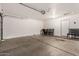 Spacious garage with an automatic door opener, interior access door, room for storage, and space for parking two cars at 15805 W Morning Glory St, Goodyear, AZ 85338