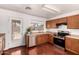 Well-lit kitchen featuring stainless steel appliances, wood cabinets, laminate countertops and a door to the patio at 15805 W Morning Glory St, Goodyear, AZ 85338