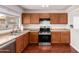 Well-lit kitchen featuring stainless steel appliances, wood cabinets, laminate countertops and a window at 15805 W Morning Glory St, Goodyear, AZ 85338