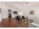 Open living room with hardwood floors, vaulted ceilings, contemporary furniture and a glimpse into the dining area at 15805 W Morning Glory St, Goodyear, AZ 85338