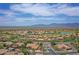Scenic aerial shot of a suburban neighborhood with green golf course in the distance and desert views at 16219 S 14Th Way, Phoenix, AZ 85048