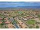 Wide aerial shot of a neighborhood with lush lawns, beautiful desert views, and community golf course at 16219 S 14Th Way, Phoenix, AZ 85048