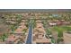 Aerial view of desert community including home with pool, desert landscaping, and golf course at 16219 S 14Th Way, Phoenix, AZ 85048