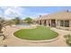 Luxurious backyard features a pool, patio, artificial grass, and desert landscaping at 16219 S 14Th Way, Phoenix, AZ 85048
