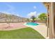 Artificial turf backyard with a swimming pool and desert landscaping at 16219 S 14Th Way, Phoenix, AZ 85048