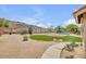 Desert backyard with artificial turf, desert landscaping, gravel, and a swimming pool at 16219 S 14Th Way, Phoenix, AZ 85048