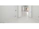 Light-filled bedroom with tile floors and an open doorway to a connecting room at 16219 S 14Th Way, Phoenix, AZ 85048
