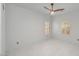 Bright bedroom featuring tile floors, plantation shutters, and a modern ceiling fan at 16219 S 14Th Way, Phoenix, AZ 85048