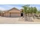 A single-story home with desert landscaping, a three car garage and a front door with decorative glass at 16219 S 14Th Way, Phoenix, AZ 85048