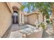 A stucco home featuring an arched doorway, pillars, decorative glass front door and desert landscaping at 16219 S 14Th Way, Phoenix, AZ 85048