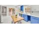 Kitchen with blue and white cabinetry and marble countertops by the breakfast nook at 16219 S 14Th Way, Phoenix, AZ 85048