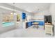 Bright kitchen boasts white and blue cabinets, marble countertops, and an island table at 16219 S 14Th Way, Phoenix, AZ 85048