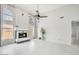 A spacious living room with high ceilings, large windows, a fireplace and white tile flooring at 16219 S 14Th Way, Phoenix, AZ 85048