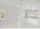 Bright living room with white walls, tile floors, plantation shutters, and modern ceiling fans at 16219 S 14Th Way, Phoenix, AZ 85048