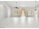 An open living space featuring white tile floors, french doors, a ceiling fan and backyard views at 16219 S 14Th Way, Phoenix, AZ 85048