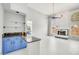 Bright living room featuring a fireplace, blue kitchen cabinets and white tile flooring at 16219 S 14Th Way, Phoenix, AZ 85048