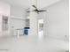 Open concept living room featuring white tile floors, bar area, and blue accent cabinets at 16219 S 14Th Way, Phoenix, AZ 85048