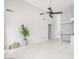Bright living room showcasing white walls and tile flooring with a modern ceiling fan at 16219 S 14Th Way, Phoenix, AZ 85048