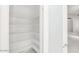 Walk-in pantry with shelving for ample storage, located just off the kitchen area at 16219 S 14Th Way, Phoenix, AZ 85048