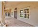 Covered patio area with tiled flooring, pillars, and views of the lush backyard and pool at 16219 S 14Th Way, Phoenix, AZ 85048
