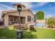 Entertainer's backyard with a pool, patio seating, lush lawn, and stylish heater at 1635 E Harrison St, Chandler, AZ 85225