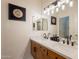Bathroom with a double vanity, framed mirrors, and modern lighting fixtures, exuding functional elegance at 1635 E Harrison St, Chandler, AZ 85225