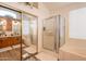 Spacious bathroom showcasing a soaking tub, a glass-enclosed shower, and double vanity with wood cabinets at 1635 E Harrison St, Chandler, AZ 85225