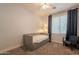 Neutral bedroom featuring a daybed with storage drawers, a ceiling fan, and a cozy armchair by the window at 1635 E Harrison St, Chandler, AZ 85225