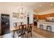 Dining room featuring a chandelier, wood table, and seating for four, adjacent to the kitchen at 1635 E Harrison St, Chandler, AZ 85225