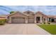 Charming single-story home with a large garage, well-manicured lawn, and inviting curb appeal at 1635 E Harrison St, Chandler, AZ 85225
