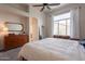 Bright main bedroom showcasing a sleek dresser, full-length mirror, and large window, creating an airy retreat at 1635 E Harrison St, Chandler, AZ 85225