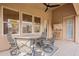 Inviting covered patio with comfortable seating, ceiling fan, and an open view to the backyard at 1635 E Harrison St, Chandler, AZ 85225