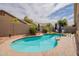 Serene pool with a view of lush landscaping, shaded umbrellas, and privacy fencing at 1635 E Harrison St, Chandler, AZ 85225