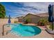 Sparkling backyard pool surrounded by lush landscaping and shaded umbrellas at 1635 E Harrison St, Chandler, AZ 85225