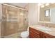 Tiled bathroom with a glass-enclosed shower, granite countertop, and ample lighting at 1874 E Huntington Dr, Tempe, AZ 85282