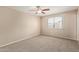 Neutral bedroom features a ceiling fan and window with bright natural light at 1874 E Huntington Dr, Tempe, AZ 85282