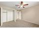 Bedroom featuring neutral tones, ceiling fan, and doorway to bathroom, and walk-in closet at 1874 E Huntington Dr, Tempe, AZ 85282