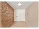 Entryway features white double doors with brick accents, and tile floors under a ceiling light at 1874 E Huntington Dr, Tempe, AZ 85282