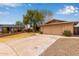 Suburban single-story home with a two-car garage, mature trees and easy to maintain desert landscaping at 1874 E Huntington Dr, Tempe, AZ 85282