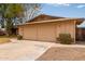 A close up of a two car garage on a one story home with mature landscaping at 1874 E Huntington Dr, Tempe, AZ 85282