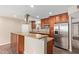 Modern kitchen with stainless steel refrigerator, granite countertops, and wooden cabinets at 1874 E Huntington Dr, Tempe, AZ 85282